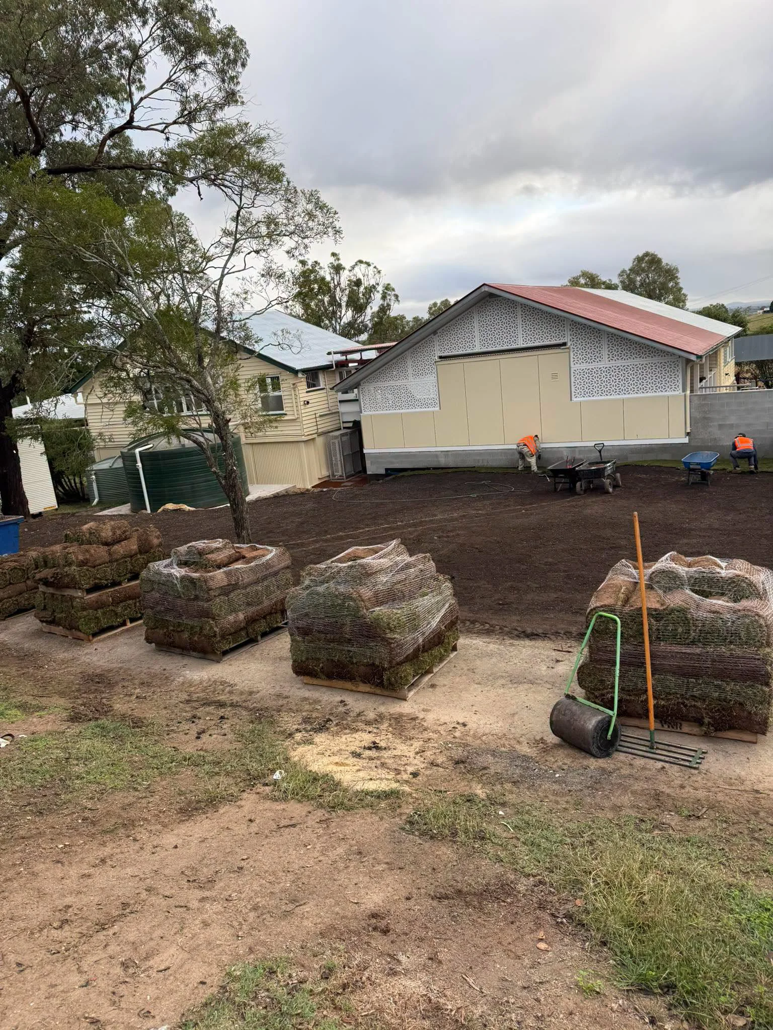 Prepared turf area and turf pallets during installation at Blenheim State School
